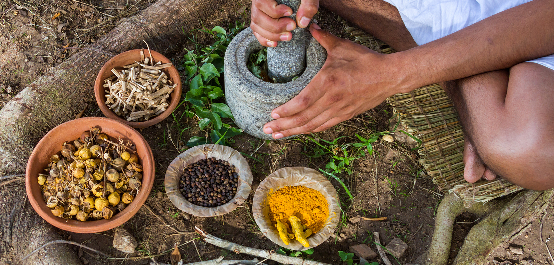 A young man preparing ayurvedic medicine in the traditional mann